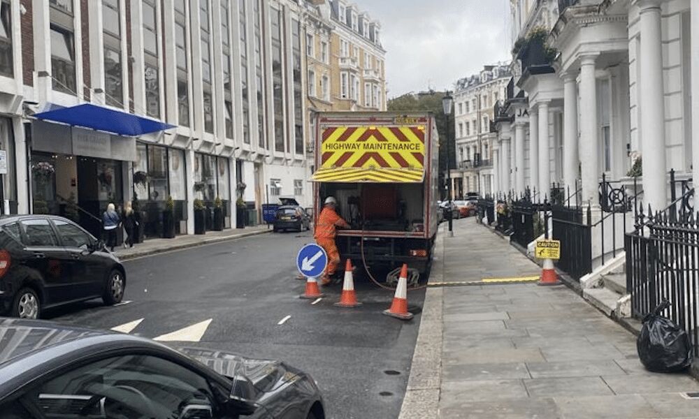 Rapid Drainage engineer unblocking a drain in London at night